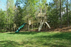 Beautiful double playset on extreme slope in Holly Springs